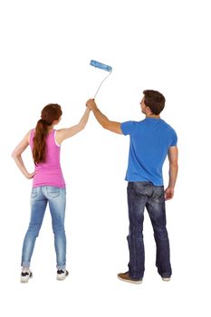 Couple painting a wall together on white background