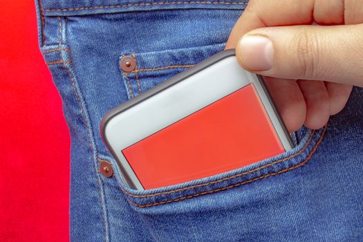 A person putting on a pocket a smart phone with a red screen