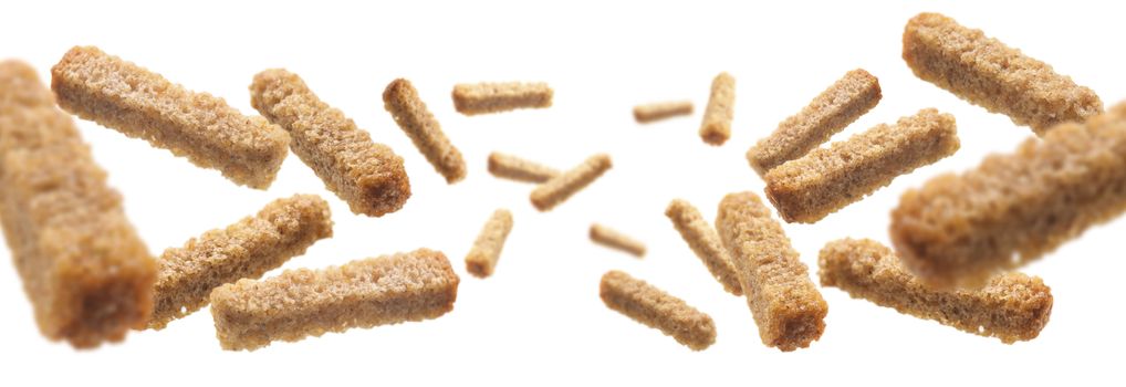 Bread croutons levitate on a white background.