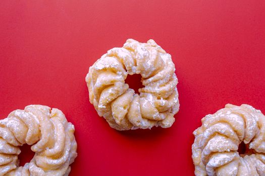 Honey Cruller Donuts on a Red Background