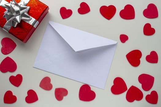 paper letter envelope with a present box gift with hearts around