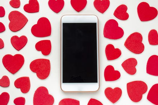 A smart phone with red hearts around on a white background