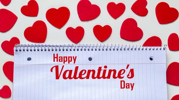 A notebook with the text: Happy Valentine's Day with hearts around