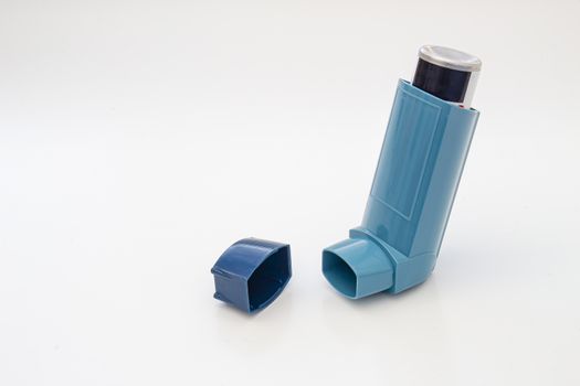 Open asthma inhaler on a white background