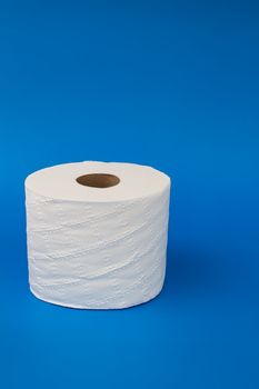 Toilet paper on a blue background with soft shadow