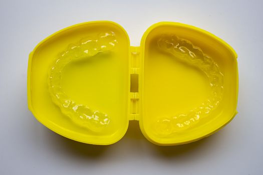 Mouth Guard on a yellow case with a white background