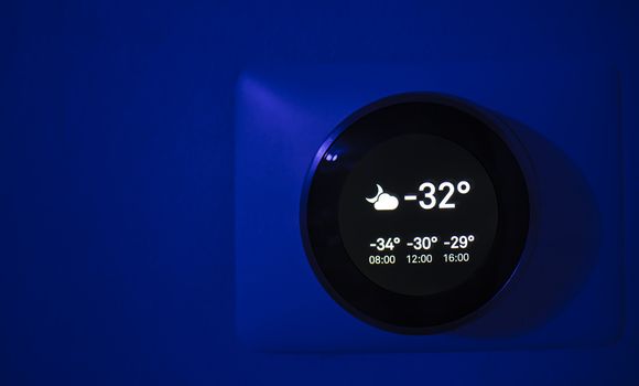 Digital Thermostat at night showing the outside temperature of -31 degrees celsius during the winter