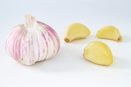 Pink, Purple and yellow Raw garlics on a white background