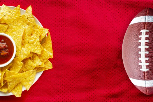 American Football Jersey textured with a football and nachos with a salsa dip on a horizontal view