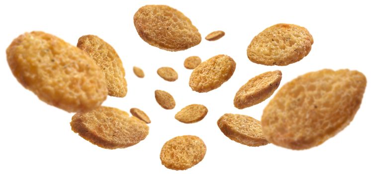 Bread croutons levitate on a white background.