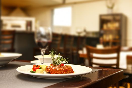 steak with tomato and pepper mit in background