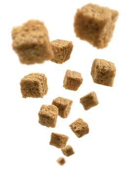 Bread croutons levitate on a white background.