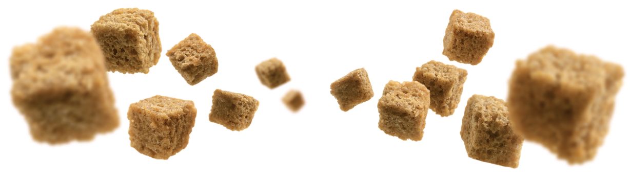 Bread croutons levitate on a white background.