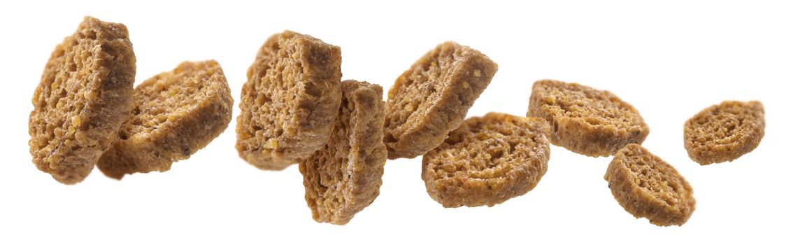 Bread croutons levitate on a white background.