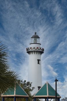 A white lighthouse in winter decorated for Christmas