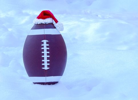 American football wearing a Santa Claus Hat on Snow