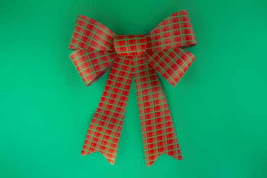 Red bow isolated on green background