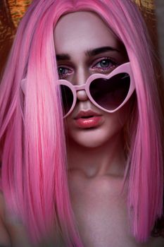 Portrait of teenage model with pink hair. Funky teenager wearing color wig and trendy glasses. Vertical photo - good format for stories