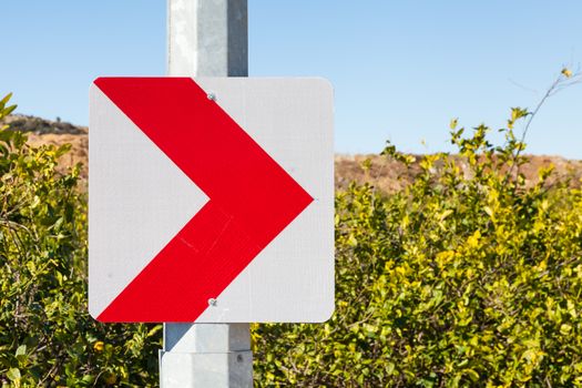 A street sign in southern Turkey indicating that the road ahead is turning right.