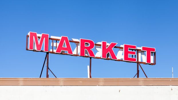 A signpost highlights the location of a local market in southern Turkey.