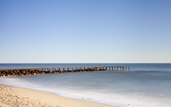 A long exposure of a landing stage in the Mediterranean Sea viewed from the southern Turkish coastline near Turkler.