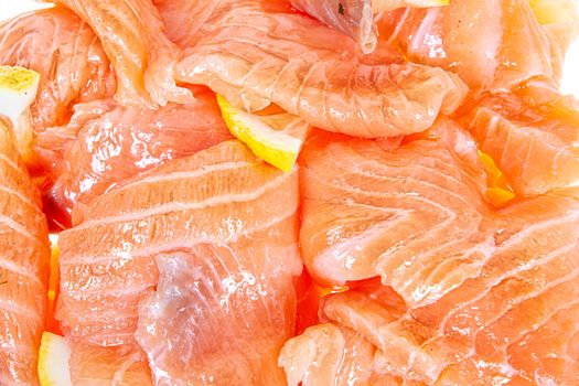 Pieces of red fish on an isolated studio background