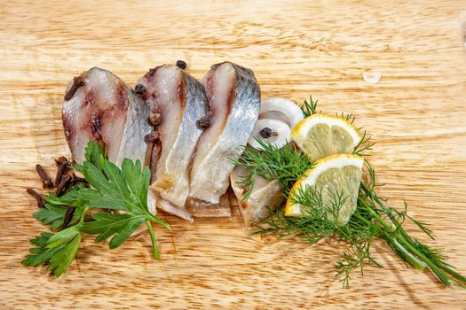 Pieces of herring ona wooden background
