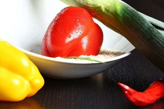 Healthy fresh organic food with water drops with rice and red and yellow pepperoni