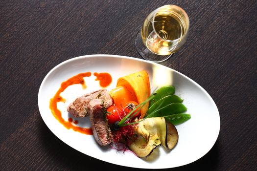 a good meal with wine. Shot from above with copy space and oval plates and a glass of wine