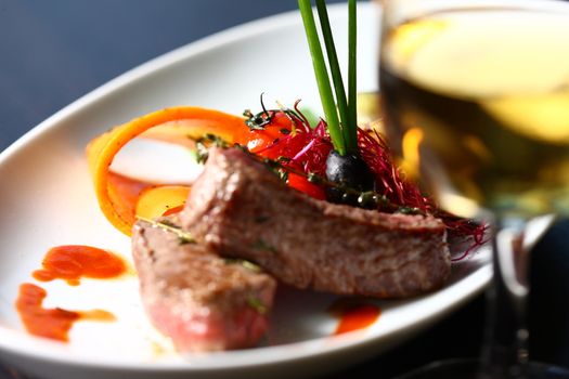 Close up a meat on a dish. A good meal on a white plate