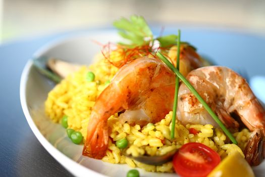 Close up of dish with shrimp and rice and wine
