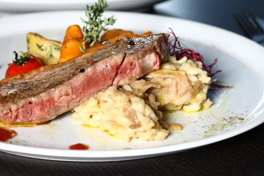 a good meal with meat and potato on a white plate