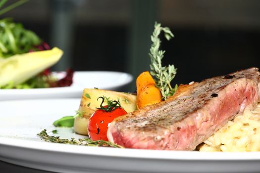 a good meal with meat and tomato on a black background