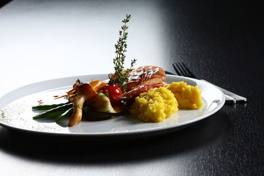 close up of dish with meat, yellow rice, mushrooms. Nice display of gourmet food