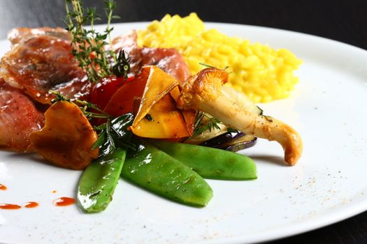 close up of dish with meat, yellow rice, mushrooms. Nice display of gourmet food. fine gourmet food.
