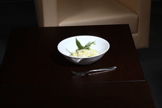 rice dish - asian food on a small dark wood table.