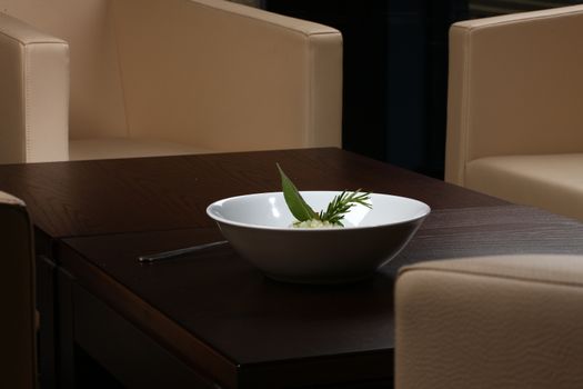 Close up of rice dish - asian food on a small dark wood table with chairs in background - rice dish - asian food