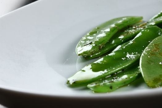 food plates on table top, ready to served for guests in a white plate. Close up of beans