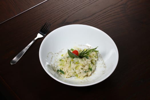 Close up of rice dish - asian food on a small dark wood table.
