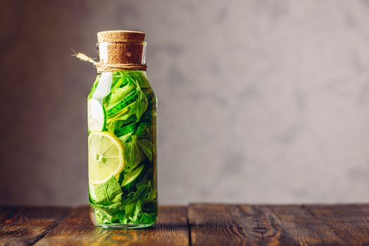 Summer Water Flavored with Sliced Lemon, Cucumber and Fresh Sprigs of Mint. Copy Space on the Right.