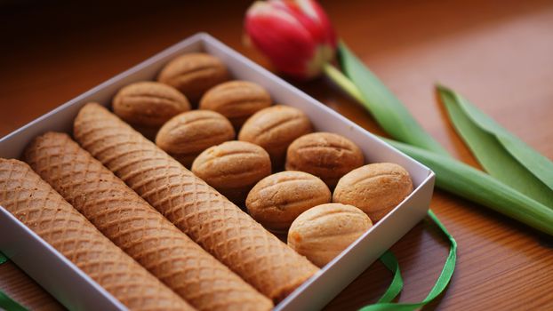 Shortbread cookies and tulips. Gift to the woman. Russian Sweets - oreshki cookies and tubes