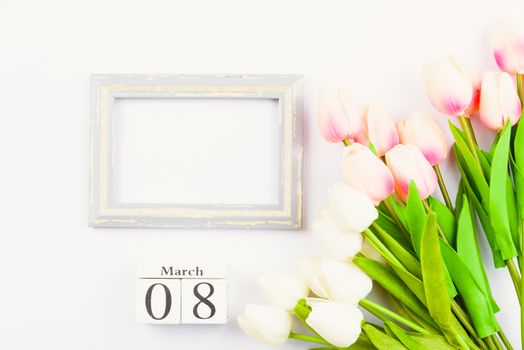 Happy Women's Day, Mother's Day and Valentine's Day concept. top view flat lay Tulip flower and photo frame on white background, copy space for your text