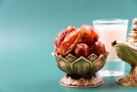Ramadan, Dates in golden bowl, Milk, arabian Aladdin golden lamp vintage style on black green background