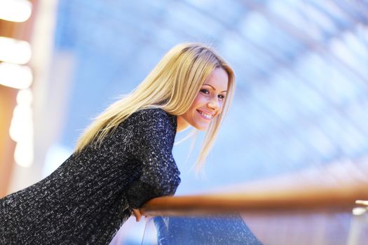 Smiling woman in modern place close up portrait