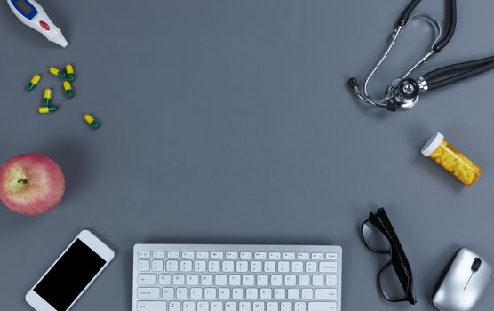 Medical equipment and technology on gray table for health care concept in flat lay setup with copy space available 