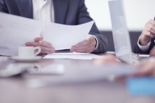 Close-up of business partners hands holding document papers , business meeting negotiation concept
