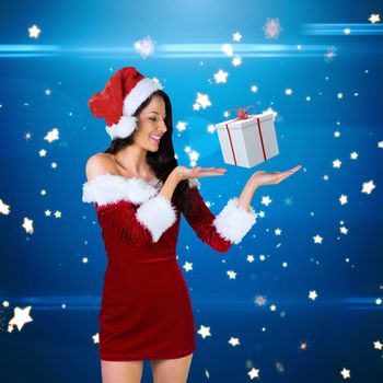 Pretty girl presenting in santa outfit against bright star pattern on blue