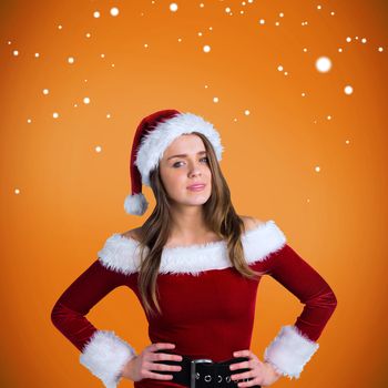 Sexy santa girl smiling at camera against orange vignette