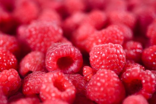 Fresh raspberries background closeup. Ripe Delicious berries. Healthy food organic concept.  