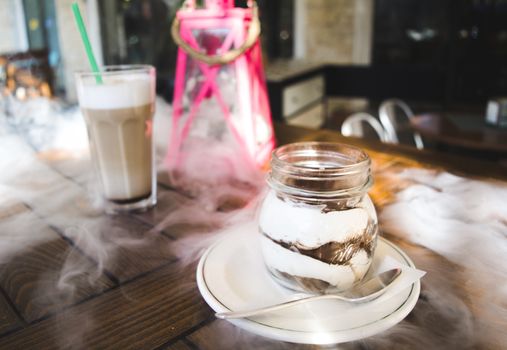 Great breakfast containing a large ice cappuccino combined with tiramisu and some smoke.